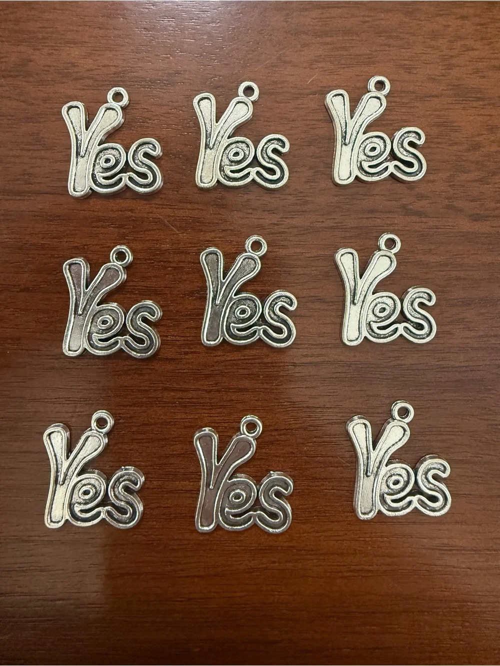 Silver Tone “Yes” Charms - 9 Total
